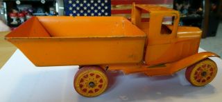 Vintage Wyandotte Press Steel Truck with wooden wheels,  spring loaded bed.  U.  S.  A 2