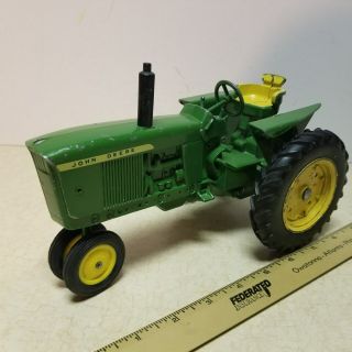 Toy Ertl John Deere 3010 row crop tractor with die cast rear rims.  1 2