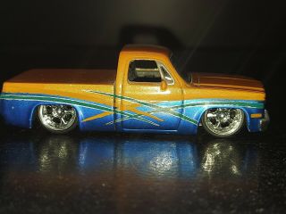 Jada Toys Dub City Kustoms 1985 Chevy Silverado C10 Pickup Blue Orange 149 1/64