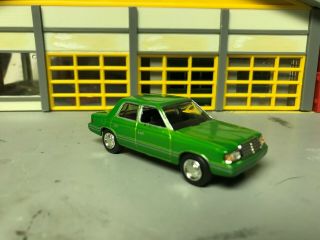 1/64 Motormax 1983 Plymouth Reliant K 4 Door/met Green/blk Int/rubber Tires