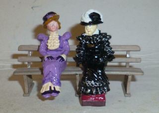 Two Unidentified White Metal Models Of Victorian Ladies Sitting On A Bench