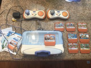 Vtech V - Motion Active Learning System.  Includes Console,  2 Controllers,  8 Game