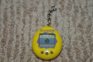 1997 Bandai Tamagotchi Yellow With Purple Buttons Virtual Pet,  Battery