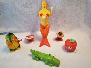 6 Vintage Hong Kong Plastic Wind Up Toys: Mermaid,  Dinosaur,  Teeth,  Alligator.