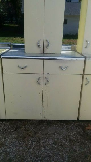Vintage Yellow Youngstown metal kitchen cabinets.  Yellow sink in 6