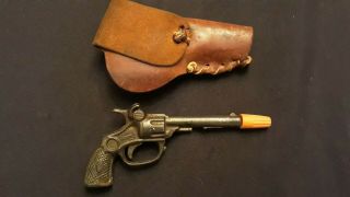 Vintage 100 Year Old Small Cast Iron Dik Cap Gun With Leather Holster.