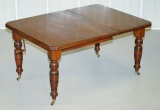 4 - 6 PERSON VICTORIAN MAHOGANY WIND OUT DINING TABLE WITH PORCELAIN CASTORS 2