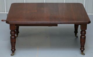 4 - 6 PERSON VICTORIAN MAHOGANY WIND OUT DINING TABLE WITH PORCELAIN CASTORS 3