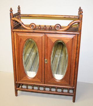 Antique Oak Stick And Ball Medicine Cabinet With Two Beveled Oval Mirrors