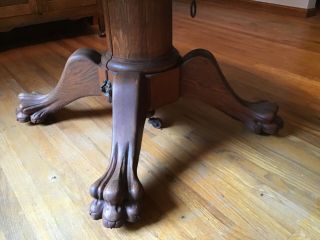 48” Round Tiger Oak Table w/clawfeet comes with 1 leaf.  Circa 1920’s 3