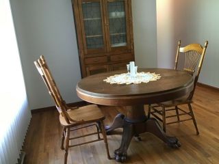 48” Round Tiger Oak Table w/clawfeet comes with 1 leaf.  Circa 1920’s 4