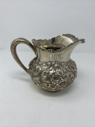 A Large Sterling Repousse Water Pitcher,  Hennegan,  Bates & Co. ,  Baltimore.