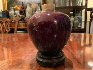 A Chinese Early Qing Dynasty Flambe Glaze Porcelain Jar With Wooden Stand.