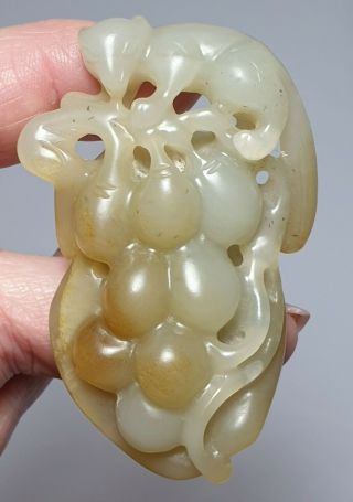 A Fine Qing Dynasty Pale Celadon Jade Carved As A Squrrel On A Grape Vine.