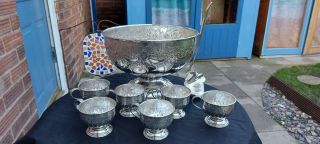 An Antique Silver Plated Hand Chased Punch Bowl.  6 Cups And Ladle.  Sheffield.