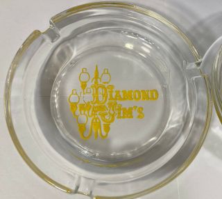 Vintage Diamond Jim ' s clear glass ashtray yellow logo 4 1/2 