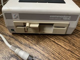 Commodore 64.  Model 1541 Disk Drive,  Wires And Booklet,  Wheel Of Fortune Game