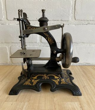 Antique German Cast Iron Childs Toy Hand Crank Sewing Machine.