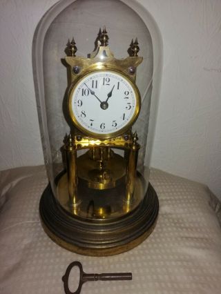 Gustav Becker Anniversary Clock In Glass Dome,  Disc Pendulum,  Needs Attention.