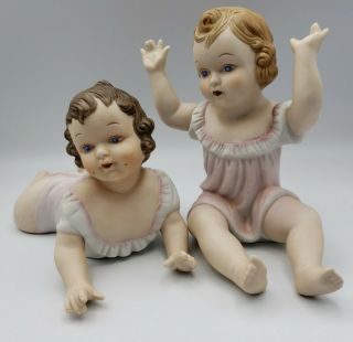 Vintage Porcelain Bisque Piano Babies Set Of 2 Brunette Blond Blue Eyes Dolls