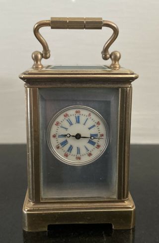 A Brass And Bevelled Glass Miniature Carriage Clock
