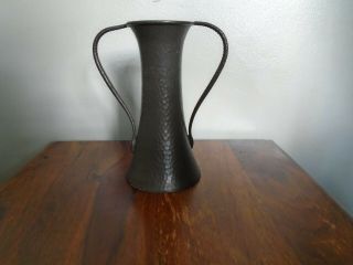 A Small Pewter Arts And Crafts Vase With Offset Snake Handles.