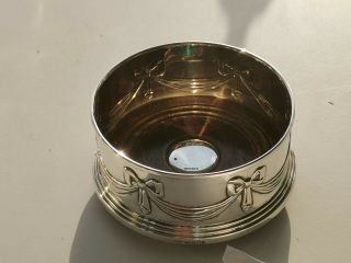 A Lovely Hallmarked Silver Wine Bottle Coaster With Scroll Ribbon Design.