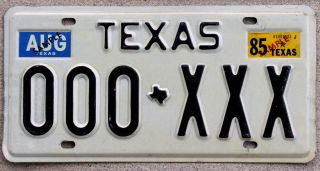 The Classic Black On White Texas Sample License Plate With A 1985 Sticker