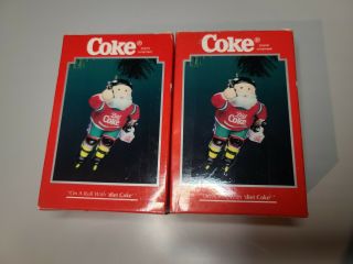 2 Vintage Enesco Roller Blade Santa Xmas Ornaments " On A Roll With Diet Coke "