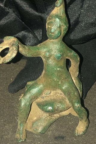An Antique Or Ancient Bronze Figure Of A Seated Male Figure Holding A Hoop