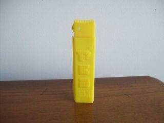 Vintage Yellow Lighter No Feet Pez Candy Container U.  S.  Patent 4.  966.  305 Hungary