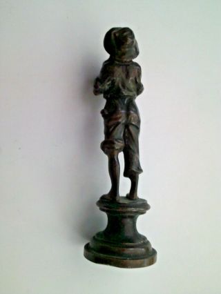 An early 20th century bronze figure of a boy holding a vase possibly Austrian 3