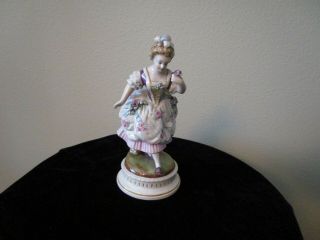 Antique Figurine Of Lady Holding Flowers A