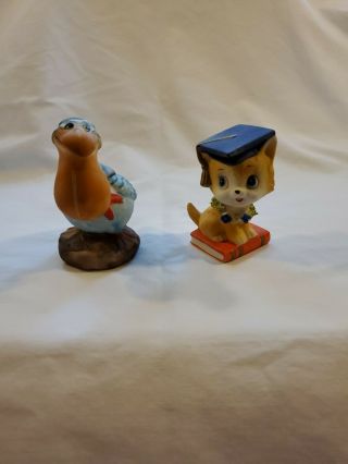 Vintage Bisque Porcelain Pelican & Graduation Cat Figurines (2)