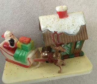 Vintage Hard Plastic Santa On Sleigh With Reindeer And House.  4 X 3”