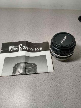 Nikon Series E 28mm F/2.  8 Lens W/ Both Covers & Booklet