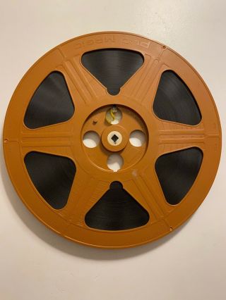 12.  25” Burnt Orange Plastic Film Reel 16mm With Film And Case