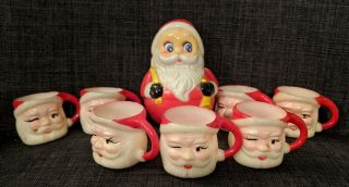 7 Vintage Winking Santa Claus Face Mini Plastic Mugs & Musical Roly Poly Santa