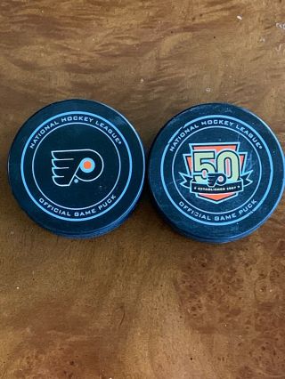 Philadelphia Flyers 50th Anniv.  Game Puck & Regular Game Puck - 2015 - 16 & 2016 - 17