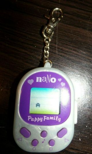 Vintage Playmates Toys Nano Puppy Family Virtual Pet Purple.