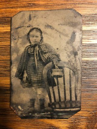Tintype Photo Of A Young Girl Standing Behind A Chair Holding A Small Bag
