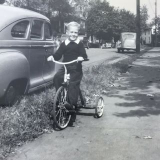 Vintage Black And White Photo Little Boy Riding Tricycle Sidewalk Street Cars
