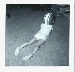 Vintage Photo Snapshot Little Boy Laying On Carpet Facing Away Wearing Helmet