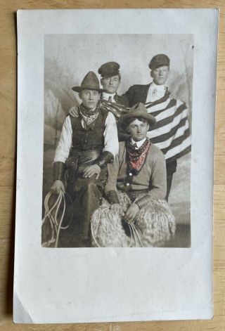 Rppc Colorized Studio View Of Four Young Men.  Two Cowboys And The American Flag.