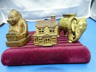 3 Antique Cast Iron Coin Banks Elephant,  Old House,  Billiken Buddha