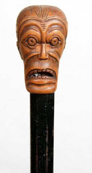 Ebony Cane With Carved Head On Top Which Has The Face Of A Really Scared Man