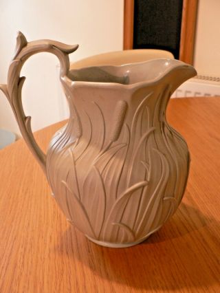 AN ANTIQUE RELIEF MOULDED DRABWARE JUG.  POSSIBLY RIDGWAY.  REGISTRATION MARK 2