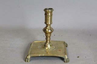 A Fantastic Early 17th C Square Base Spanish Brass Candlestick Brushed Paw Feet