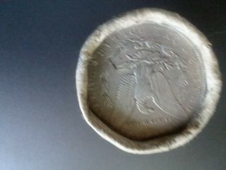 roll of 20 silver dollars with an O showing and an S showing on the ends 3