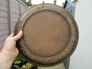 An Antique Carved Wooden Bread Board - " Manners Makyth Man " - 30 Cm Diameter.